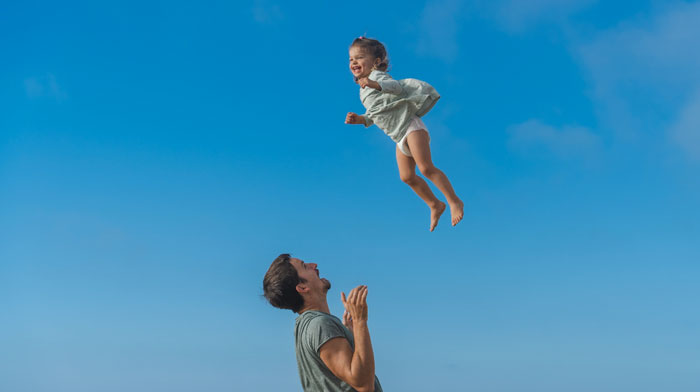 Father and child playing, cover for helping children feel more secure article