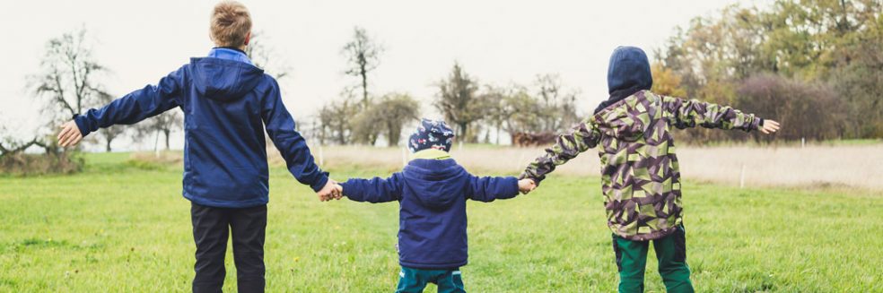 Children holding hands. My children don't know I had a child adopted